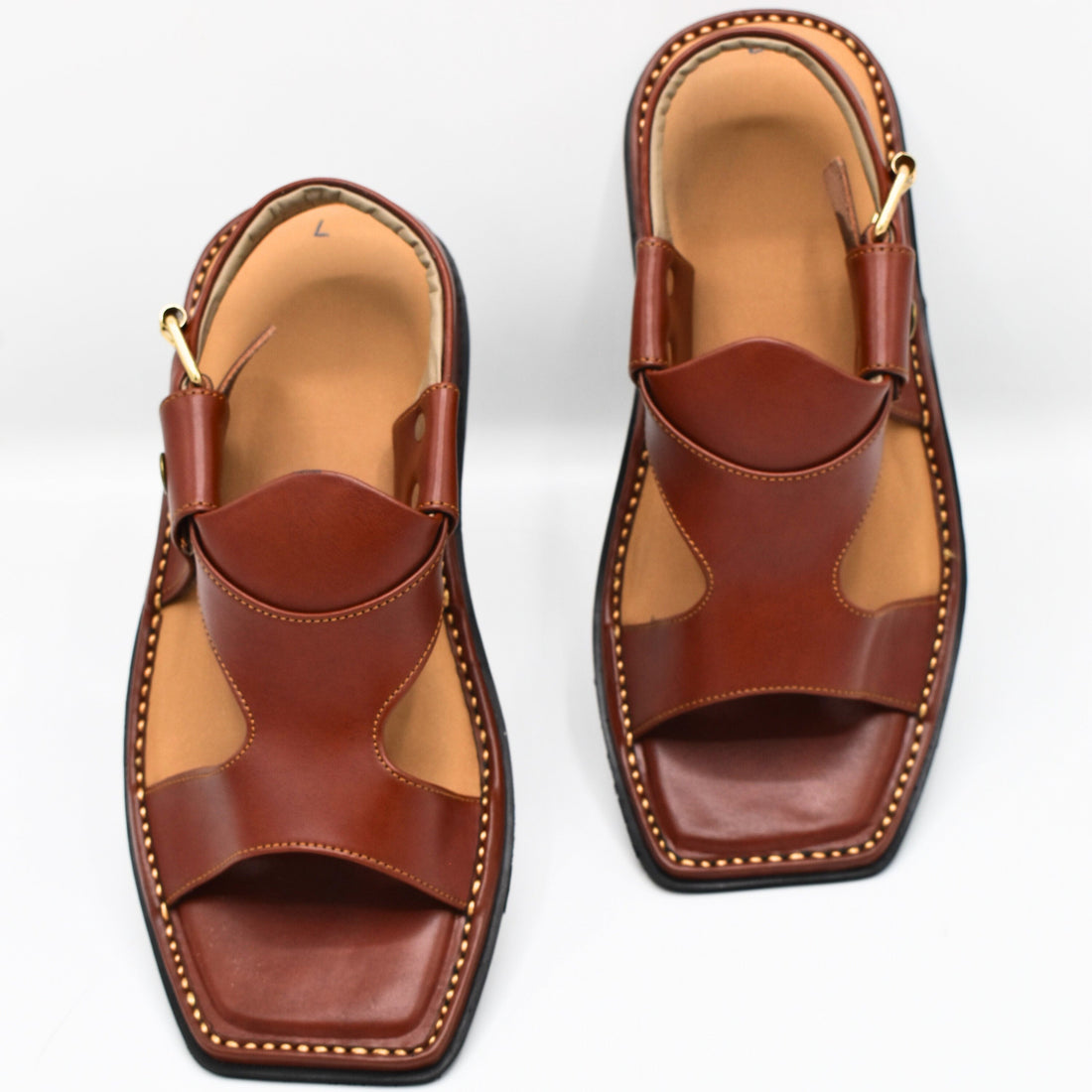 Pair of brown leather sandals on a white background